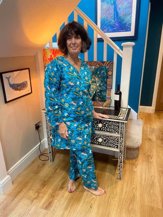The most gorgeous bright refreshing blue pyjamas for women with botanical design or leaves and flowers in white, yellow and peach.  Long length pyjama top with long sleeves and no buttons for style and comfort. Pyjamas for women to sleep or lounge in luxury.  Available in 3 sizes - Medium, Large and Extra Lagre. Beautifully soft 100% Cotton Long Length Top Comes with cute matching bag. 