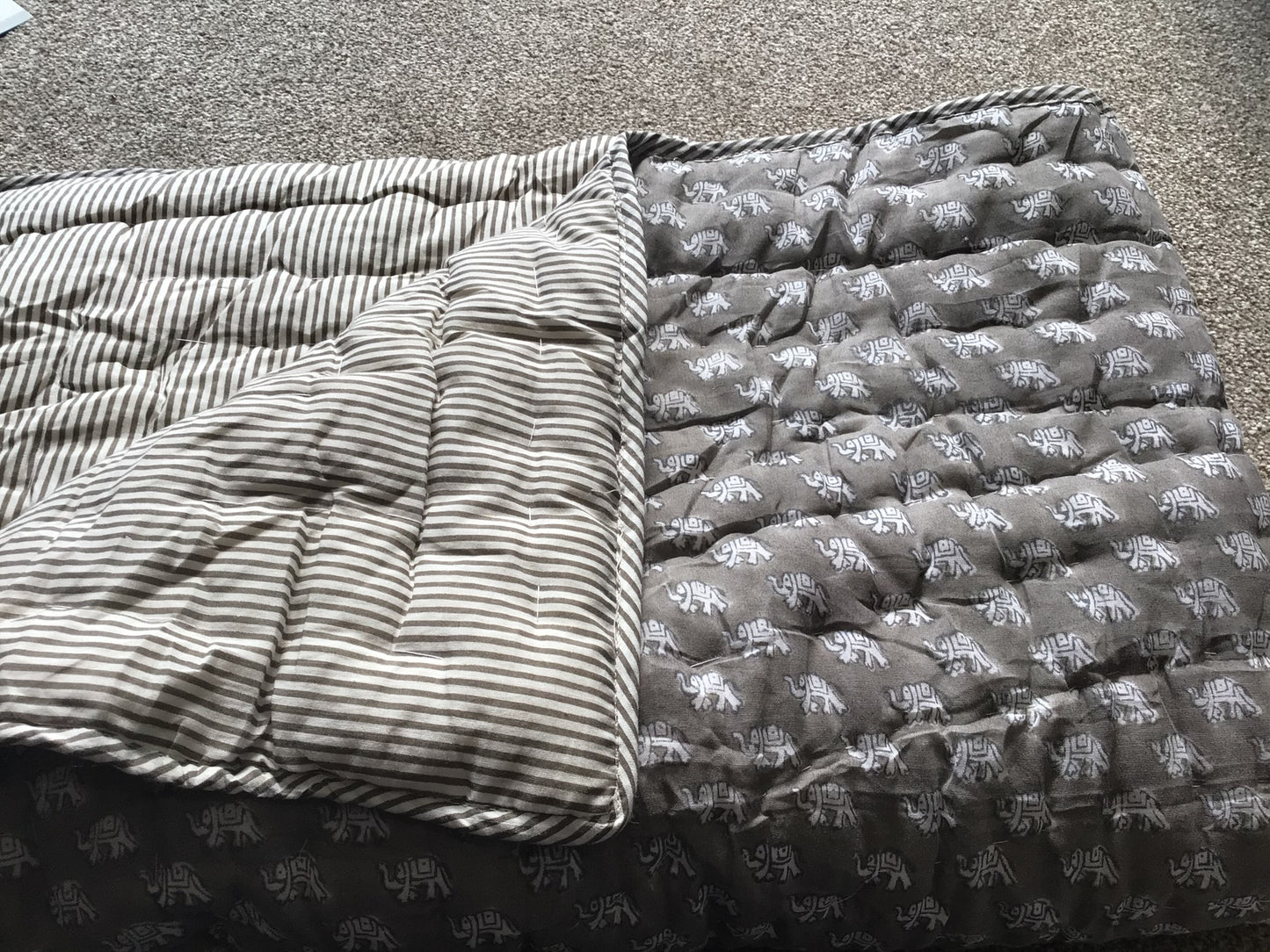 Mia elephant baby quilt grey background with white elephant design. Gorgeously wrapped gift, perfect as a Christening or unique gift for a new baby Colour: White elephants on grey background with grey and white striped reverse. Size: W186 x L100cm Material: 100% cotton Baby quilt, quilt for babies. Our 100% hand block printed cotton baby quilts are perfect for bed time, play time, on the beach or for a picnic Colour: white elephant with grey striped reverse, Rowan Charles, Baby Play mat, Play mats for baby